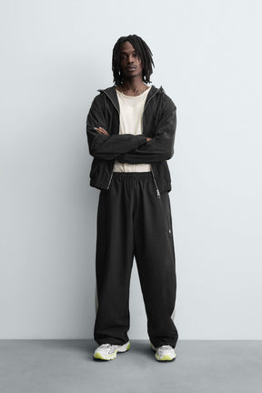 TECHNICAL TROUSERS WITH TAPING - Image 1